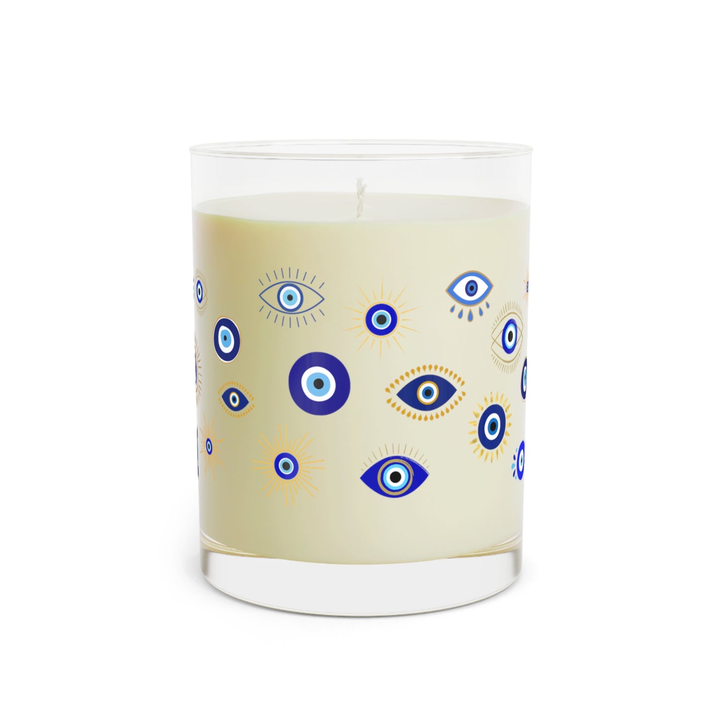 Candle with evil eye pattern design on a beige background
