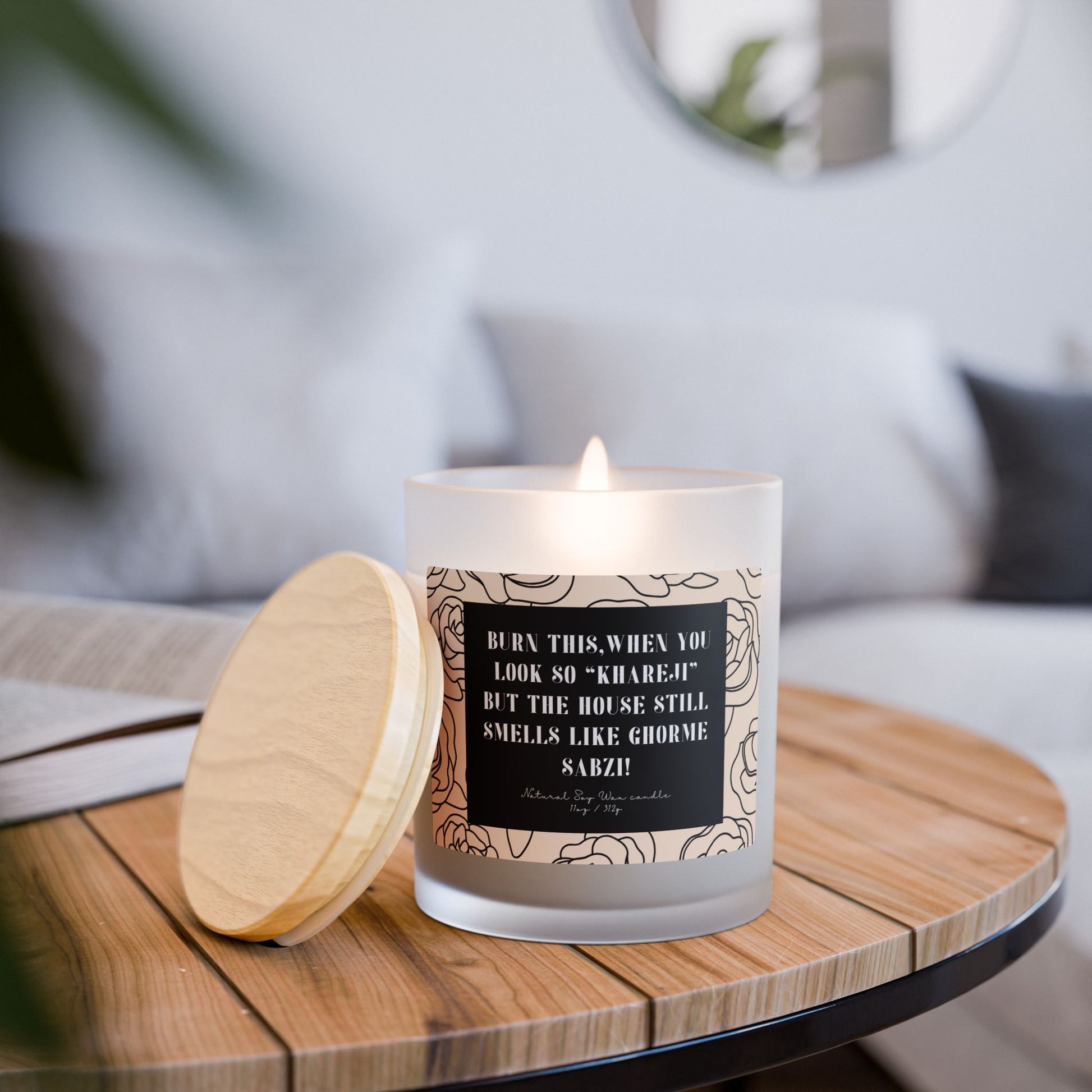 Candle with a decorative label on a wooden table