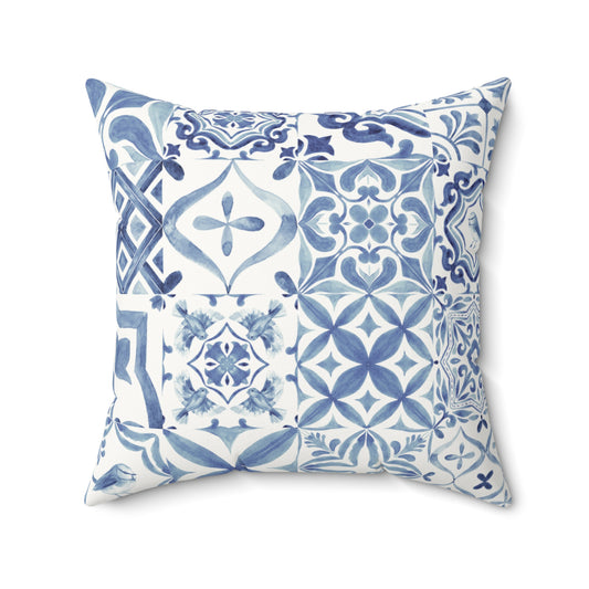 Decorative pillow with blue and white geometric pattern on a white background
