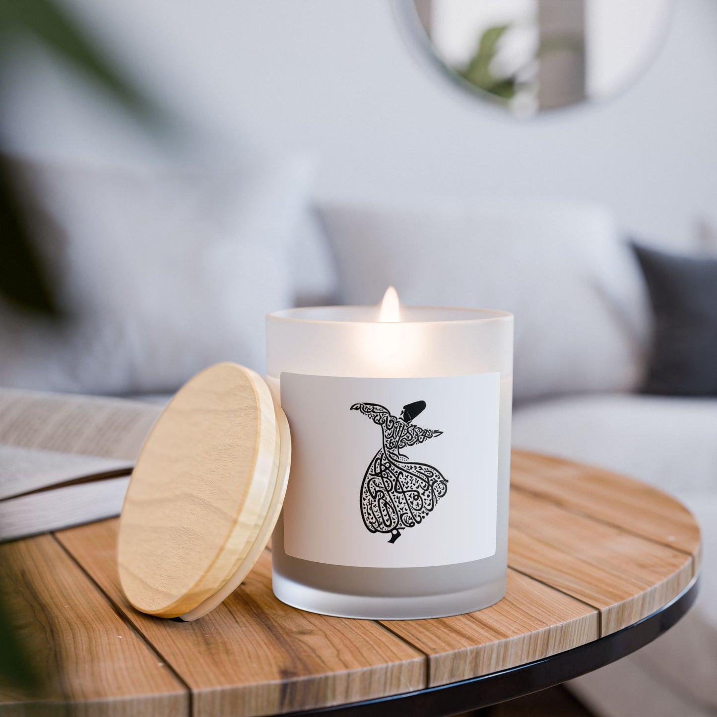 Candle with a darvish dancing label on a wooden table in a cozy indoor setting