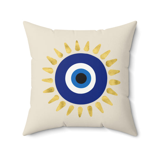 Decorative pillow with a blue and white devil eye design and gold accents on a beige background