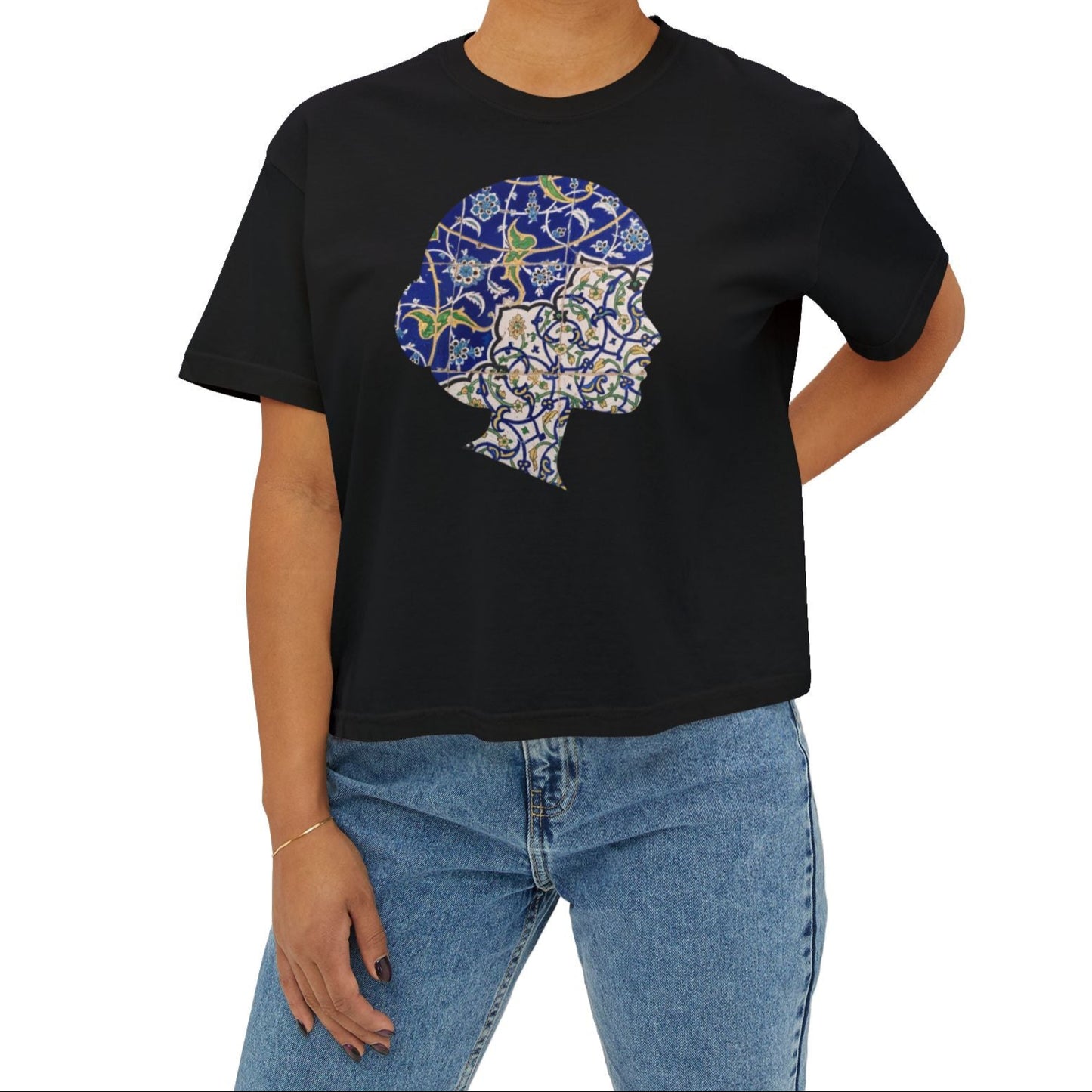 Person wearing a black t-shirt with a colorful Persian tile graphic design on a white background