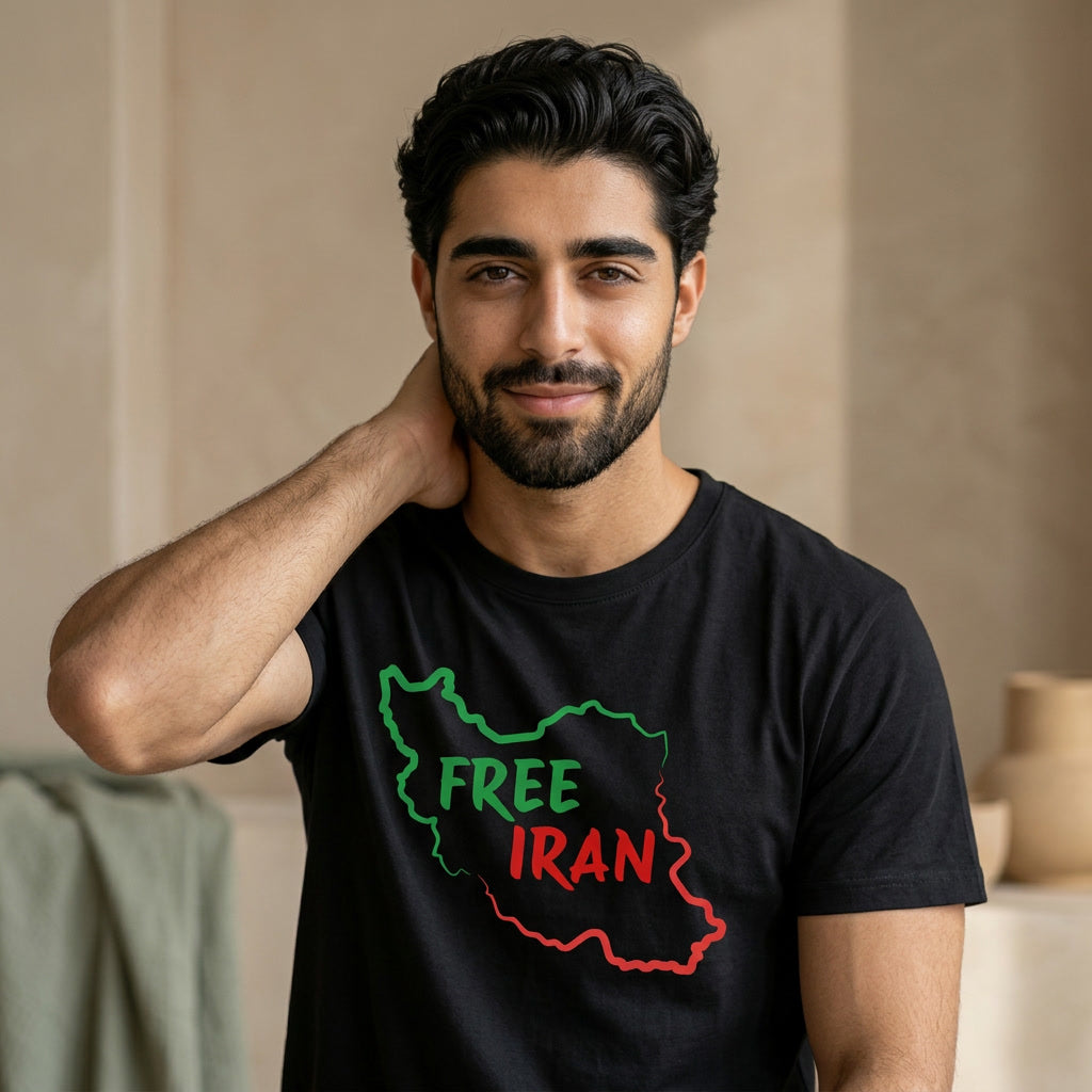 Man wearing a black t-shirt with 'FREE IRAN' design, sitting indoors.