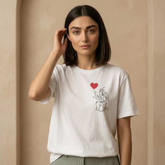 Woman wearing a white t-shirt with an Iranian angel and heart design on the chest. 