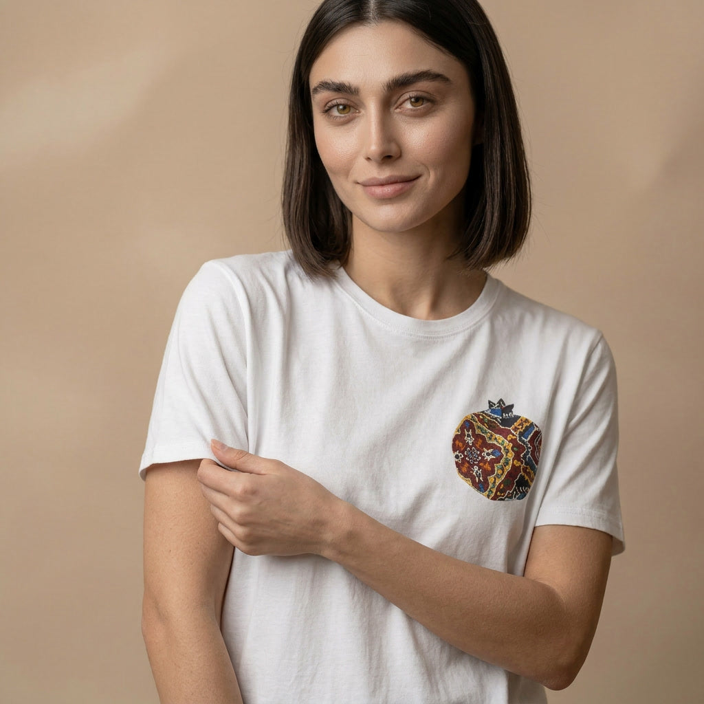 Woman wearing a white t-shirt with a colorful graphic on a beige background