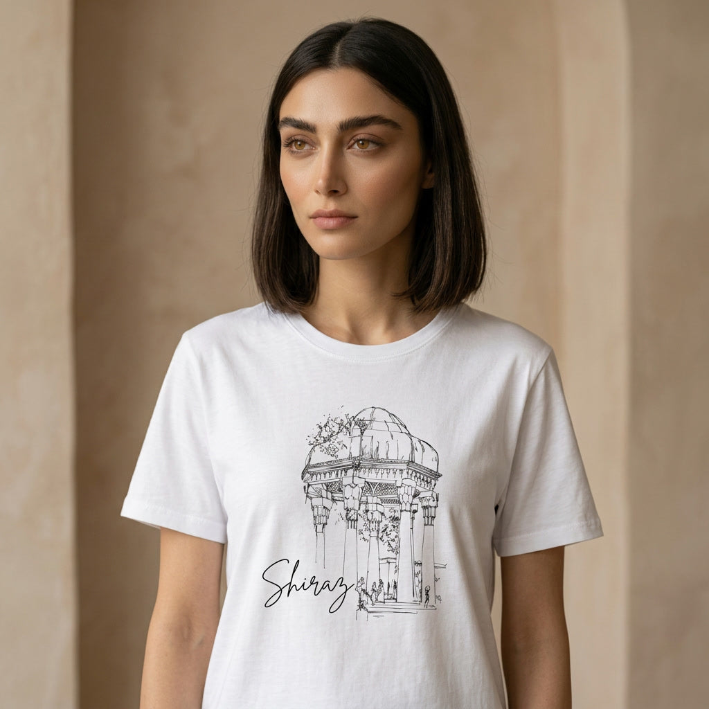 Woman wearing a white t-shirt with a black architectural design of Hafez Tomb and 'Shiraz' text on a beige background