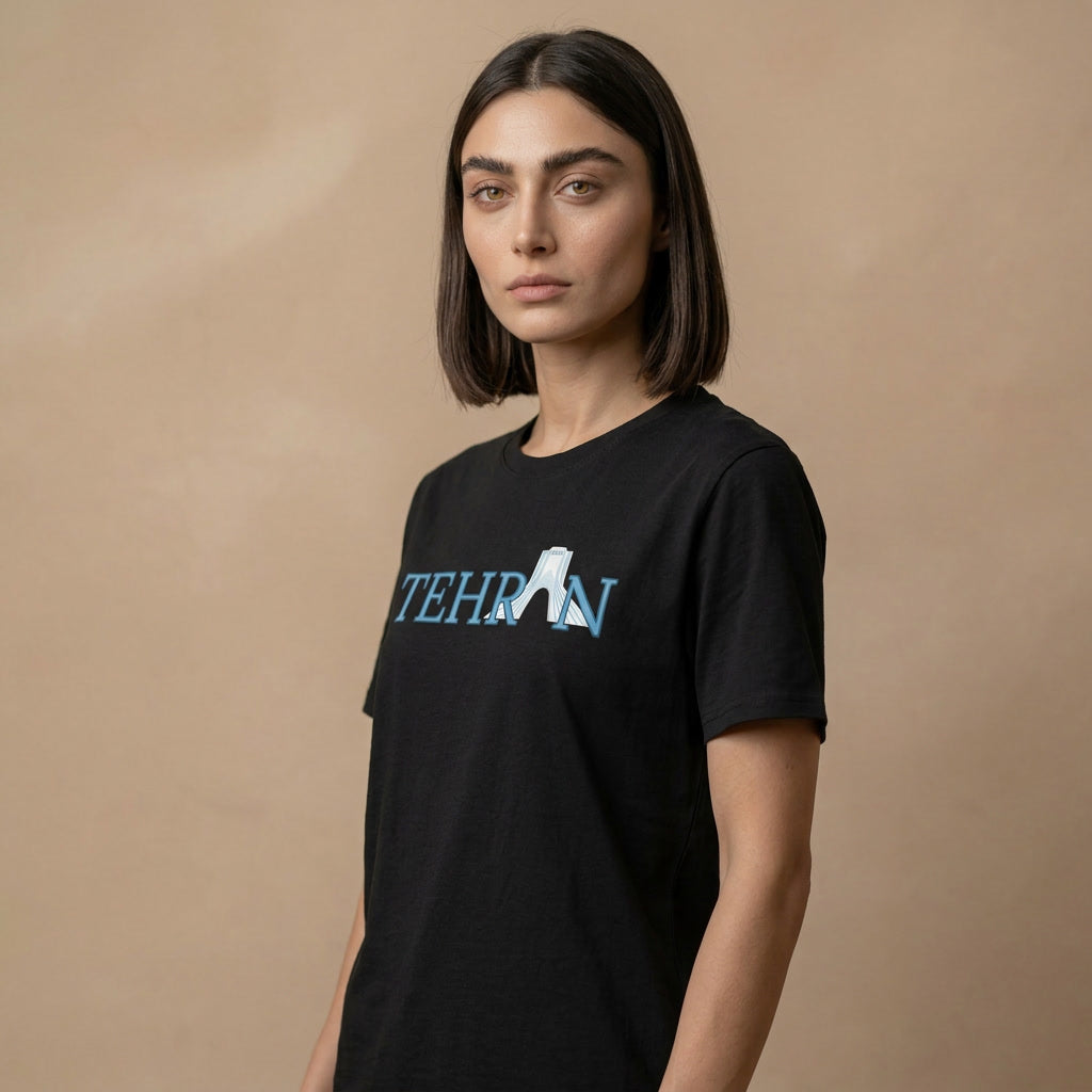 Person wearing a black t-shirt with 'TEHRAN' printed on it against a beige background