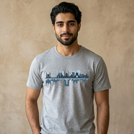 Man wearing a gray t-shirt with a graphic of the Tehran skyline design on a beige background