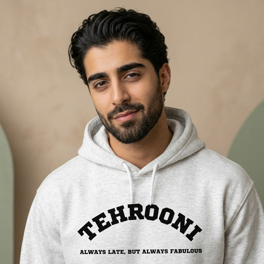 Man wearing a gray hoodie with Tehrooni on it.
