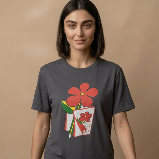 Woman wearing a dark gray t-shirt with a graphic design of red flowers on a beige background