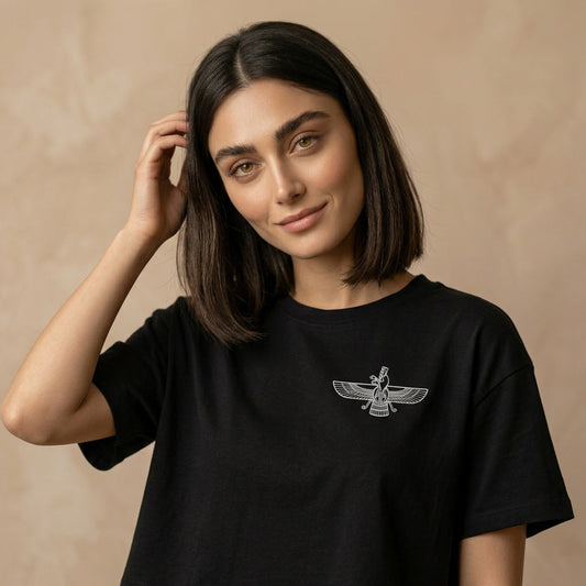 Woman wearing a black t-shirt with a white Farvahar sign on its chest on a beige background 