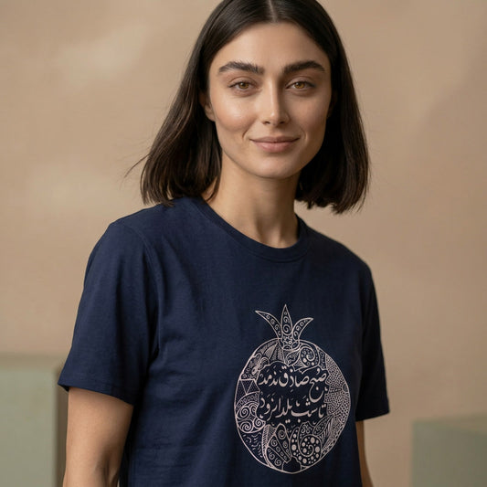 Woman wearing a navy blue t-shirt with a decorative design on a beige background