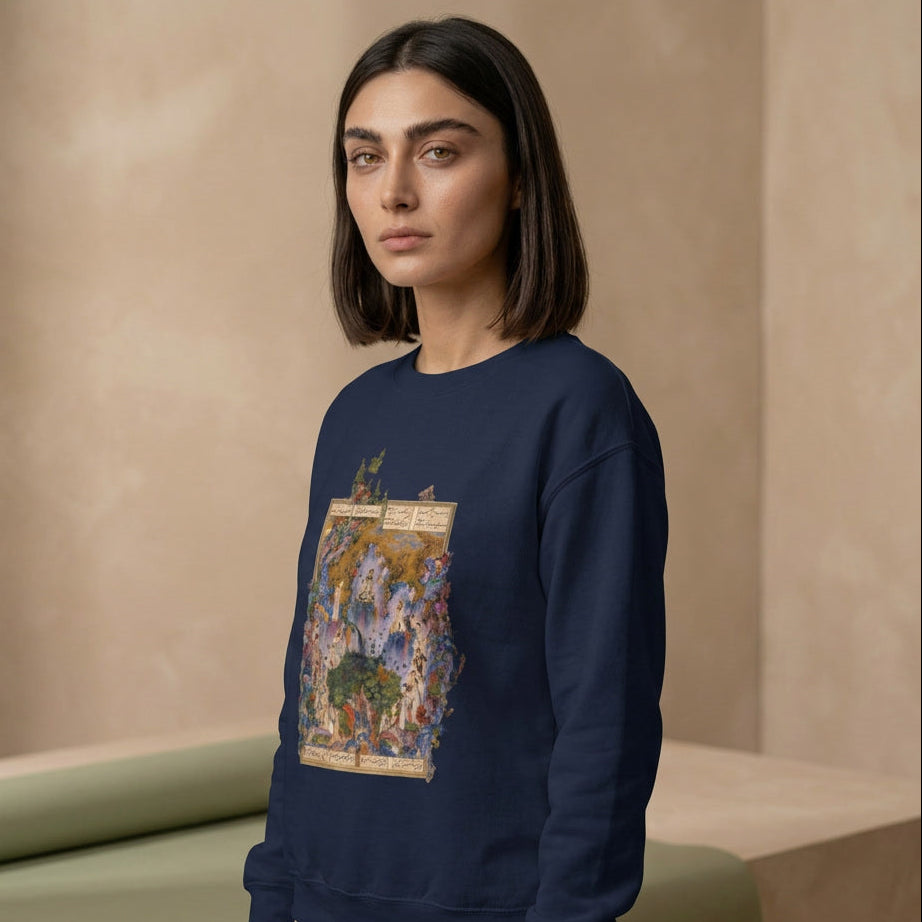 Woman wearing a navy blue sweatshirt with a colorful graphic design against a beige background